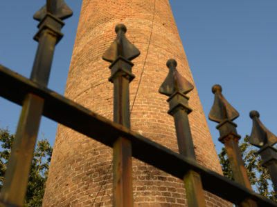Located along Pensacola Scenic Bluffs Highway, Chimney Park contains an approximately 50-foot high brick chimney, remnants of a pre-Civil war era sawmill. The property is configured as a “mini” park functioning as a roadside rest area containing parking spaces and brick walkways.