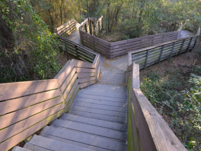 The city-owned, 32-acre Bay Bluffs Park features an extensive boardwalk that leads visitors through thick forest to the base of the giant cliffs and the waters of Escambia Bay. Tall bluffs of red clay line the beaches, which offer a magnificent spot to watch the sun rise over the bay.