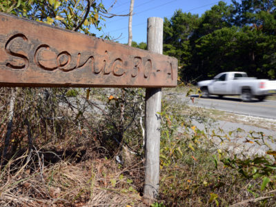 A vehicle passes a hand-made address sign along Scenic Highway 30A in Walton County, Florida. | Photo by: Andrew Wardlow