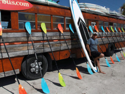 Bradenton Florida. 2/22/2016. Shawn Duytschaver has rented kayaks and paddle boards from his Surfer Bus since 1989. He is parked at the west end of the Palma Sola Scenic Highway near the Robinson Preserve. On the ground photos of the Palma Sola Scenic Highway and areas along it. Photo by Bill Serne