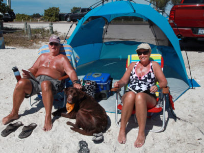 Bradenton Florida. 2/22/2016. Jim and Hollis Resnik from Troy, New York enjoy the sand and water at the west end of the Palma Sola Scenic Highway. With them is Brandy. On the ground photos of the Palma Sola Scenic Highway and areas along it. Photo by Bill Serne