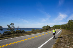 Bicyclists ride the Coastal Trail portion of the Big Bend Scenic Byway along U.S. Highway 98 near Leonard's Landing on Alligator Harbor. COLIN HACKLEY PHOTO