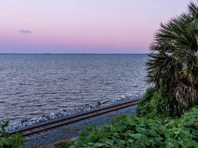 Rail line tracing the bay below the bluffs